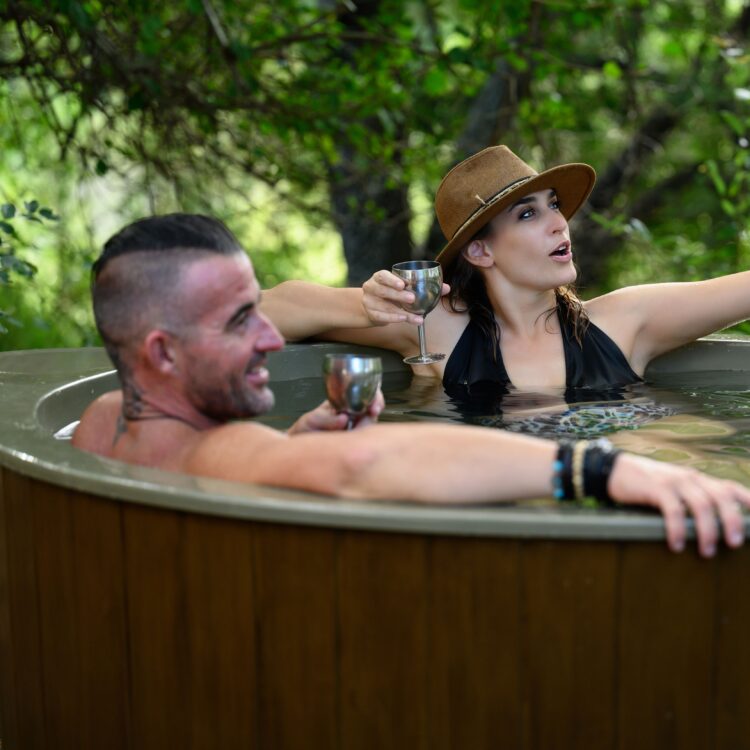 Couple sitting inside Wooden Hot Tub